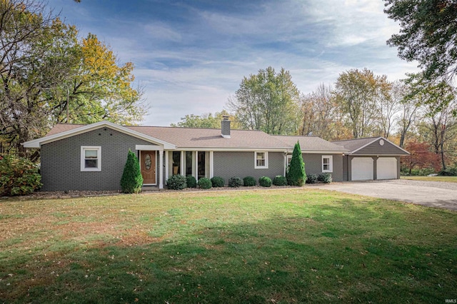 ranch-style house with a garage and a front lawn