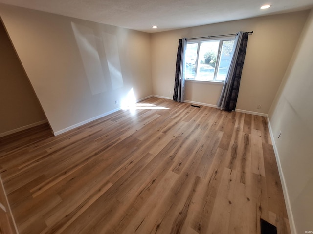 spare room featuring light hardwood / wood-style flooring