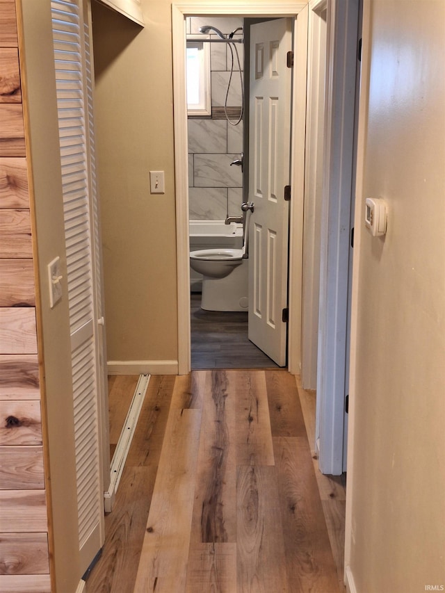 corridor with light hardwood / wood-style floors