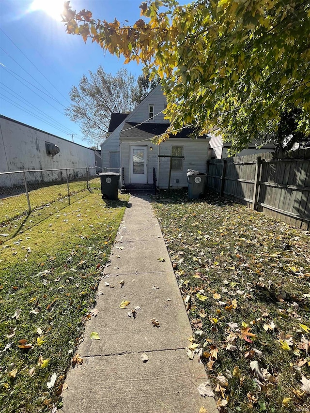 rear view of house with a yard