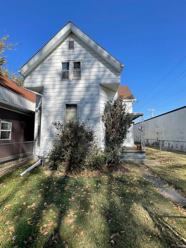 back of house with a lawn