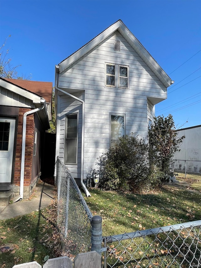 view of side of home featuring a lawn