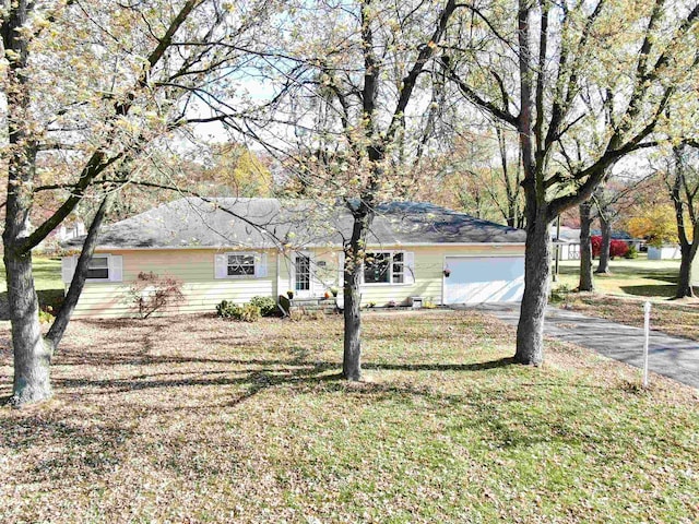 ranch-style house with a front yard and a garage