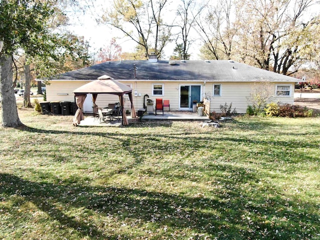 rear view of house featuring a gazebo, a patio area, and a lawn