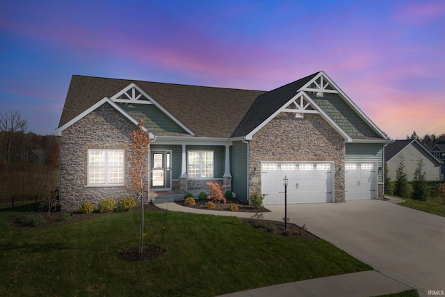 craftsman-style house featuring a garage and a lawn