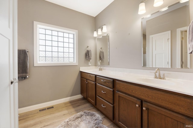 bathroom with vanity and hardwood / wood-style flooring