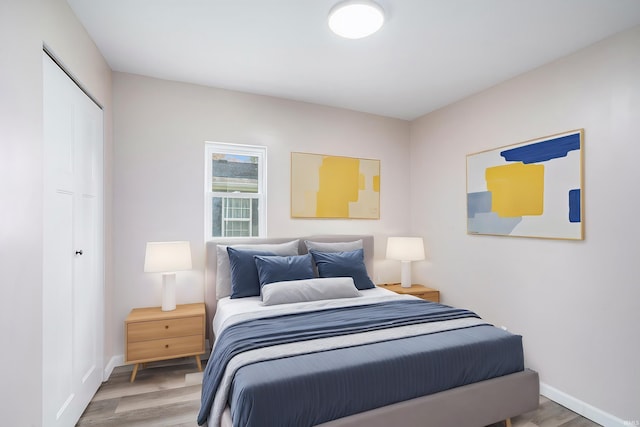 bedroom with hardwood / wood-style flooring and a closet