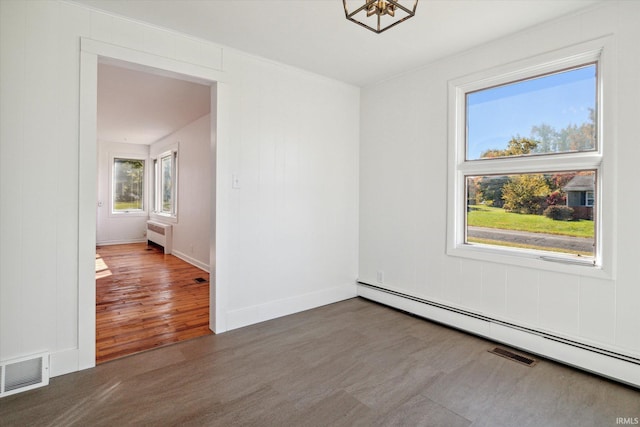 spare room with radiator heating unit, baseboard heating, and dark wood-type flooring