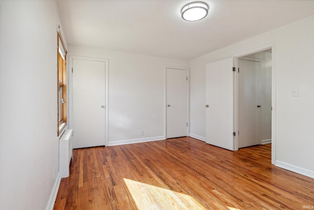 spare room featuring wood-type flooring