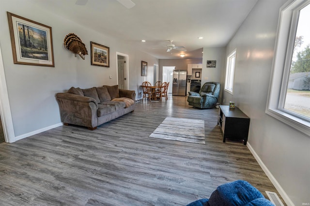 living room with hardwood / wood-style floors and ceiling fan