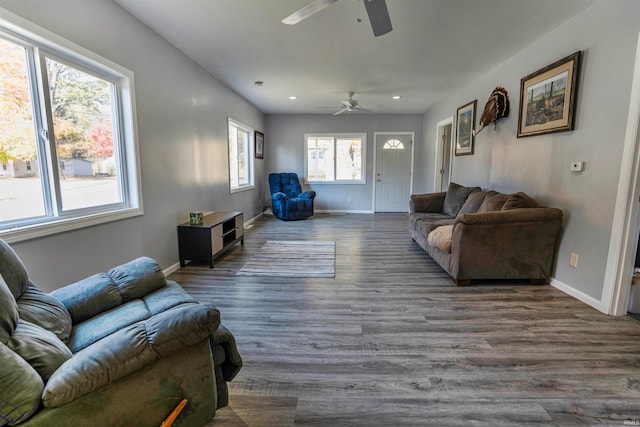 living room featuring dark hardwood / wood-style floors and ceiling fan