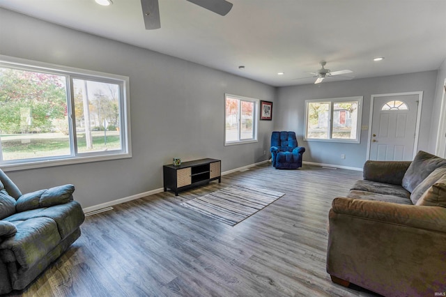 living room featuring hardwood / wood-style flooring and ceiling fan