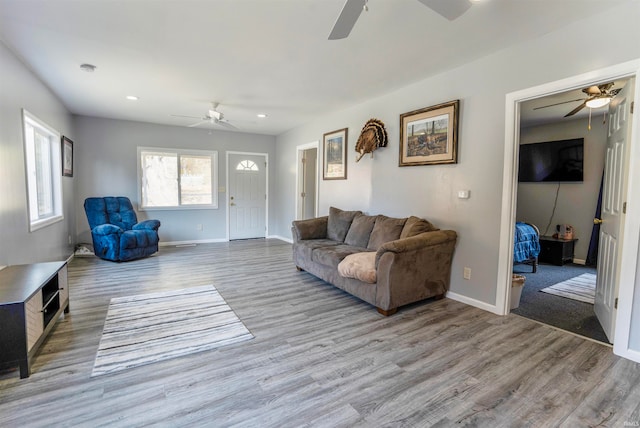 living room featuring light hardwood / wood-style floors and ceiling fan