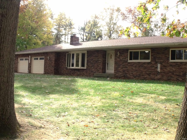 ranch-style home with a front lawn and a garage