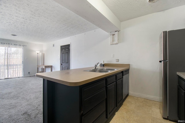 kitchen featuring sink, kitchen peninsula, stainless steel appliances, and a textured ceiling