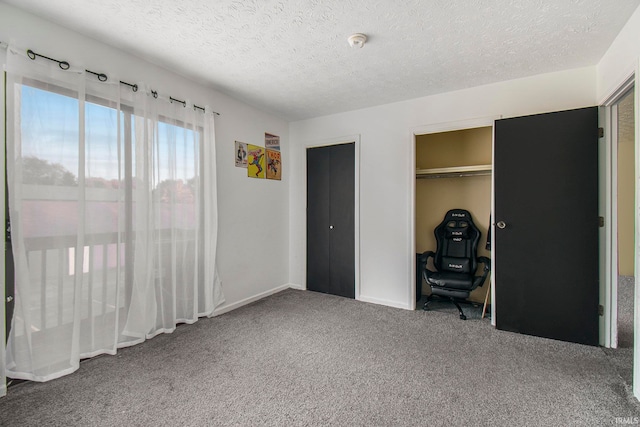 unfurnished bedroom with a closet, a textured ceiling, and carpet floors