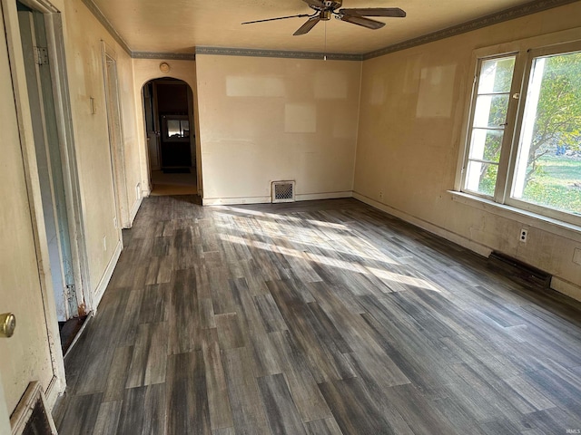 empty room featuring crown molding, dark hardwood / wood-style floors, and ceiling fan