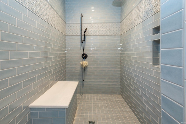 bathroom with tile walls and tiled shower