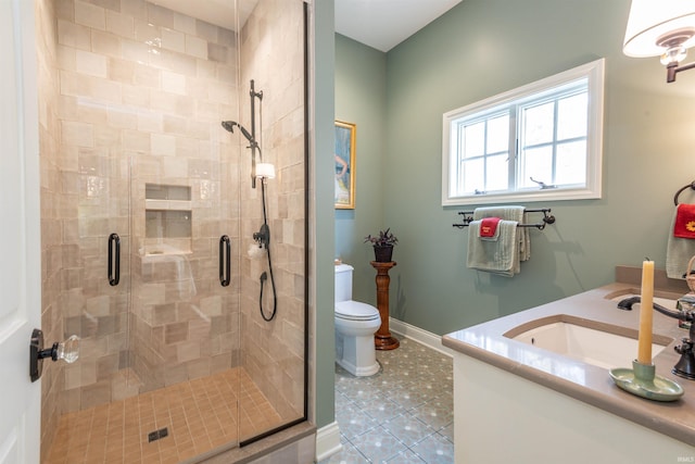 bathroom with toilet, walk in shower, vanity, and tile patterned flooring