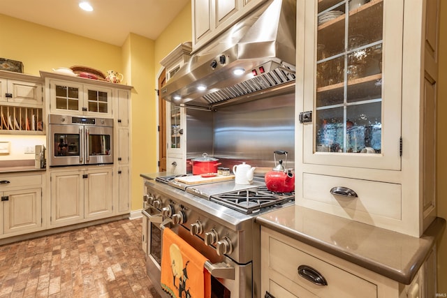 kitchen featuring appliances with stainless steel finishes and cream cabinets