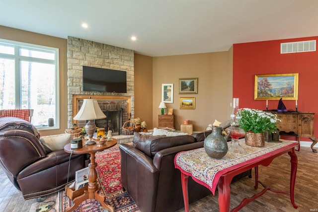 living room featuring wood-type flooring and a fireplace