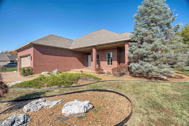 view of front of home with a front yard and a garage