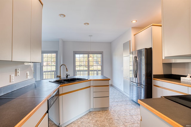 kitchen featuring sink, white cabinetry, and stainless steel appliances