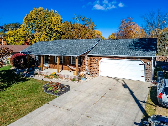 ranch-style home featuring a front yard, a garage, and a porch