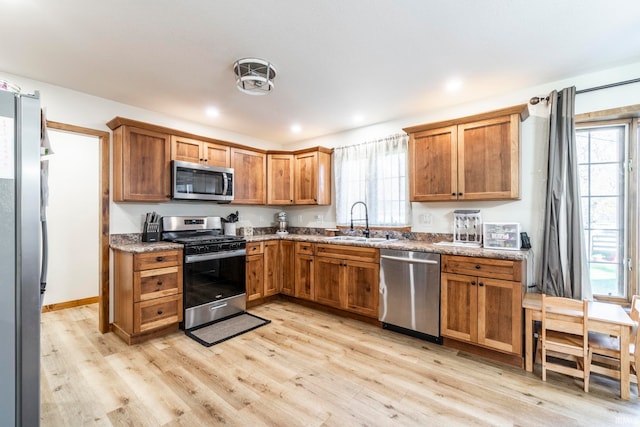 kitchen featuring appliances with stainless steel finishes, a healthy amount of sunlight, and sink