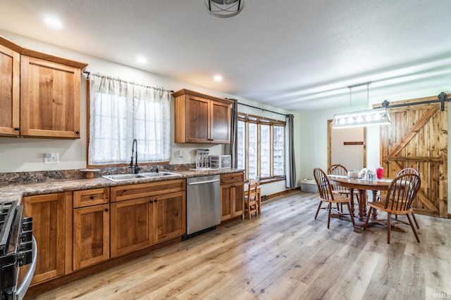 kitchen featuring light hardwood / wood-style floors, a healthy amount of sunlight, stainless steel appliances, and sink