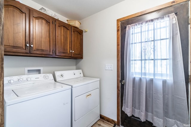 washroom with washer and clothes dryer, light hardwood / wood-style floors, and cabinets