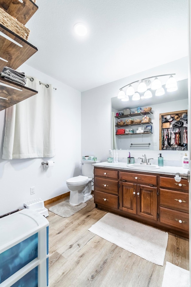 bathroom with vanity, hardwood / wood-style floors, and toilet