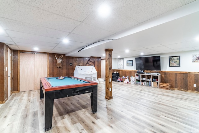 rec room featuring light hardwood / wood-style floors, a drop ceiling, wooden walls, and pool table