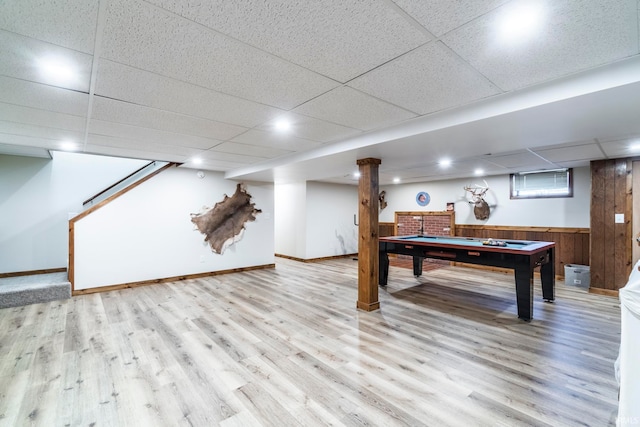 game room featuring a paneled ceiling, billiards, light wood-type flooring, and wooden walls