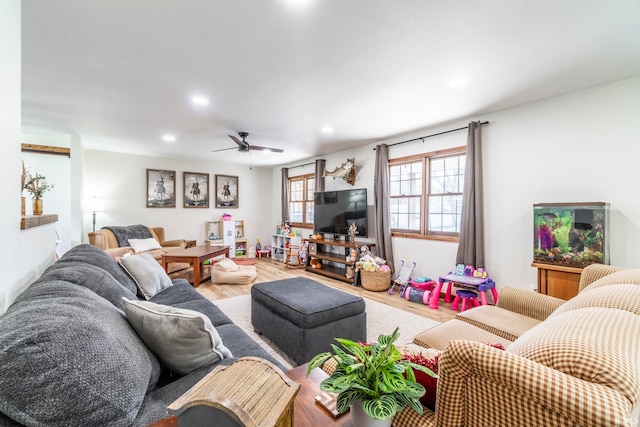 living room with wood-type flooring and ceiling fan