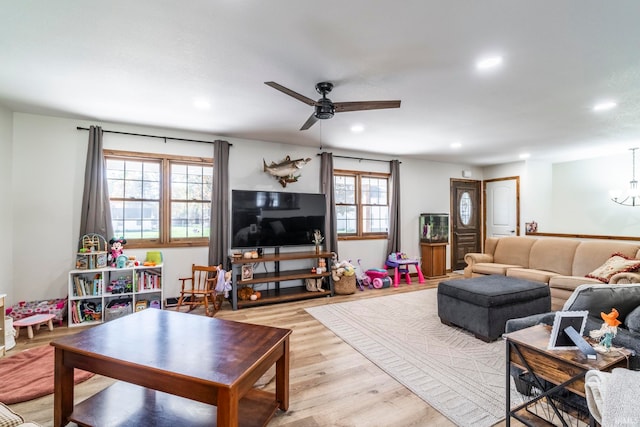 living room featuring light hardwood / wood-style flooring and ceiling fan