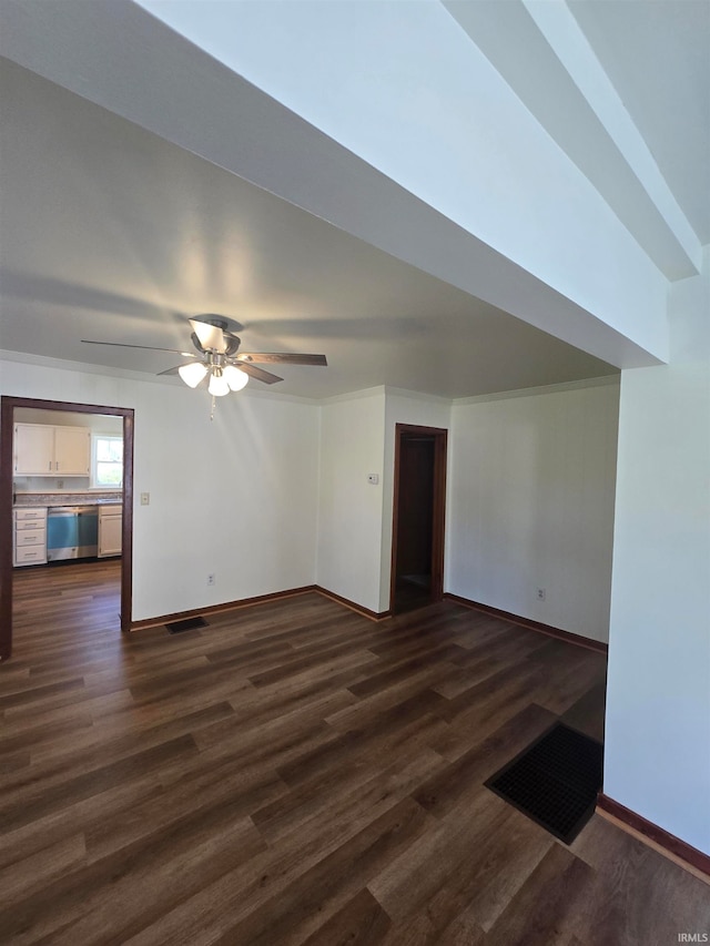 unfurnished living room featuring ceiling fan and dark hardwood / wood-style flooring