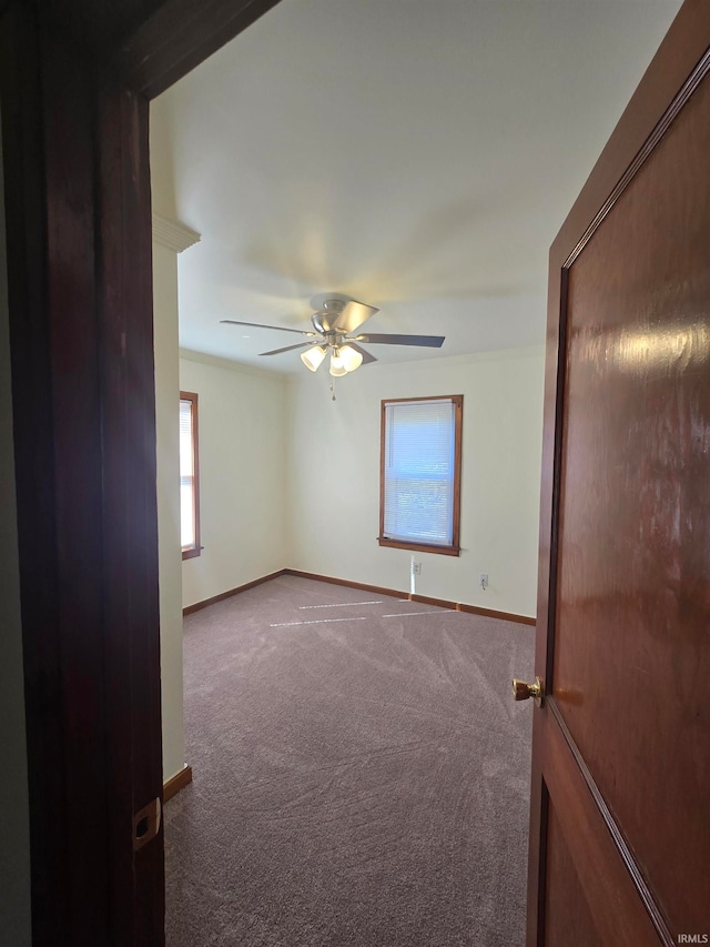 spare room featuring carpet flooring and ceiling fan