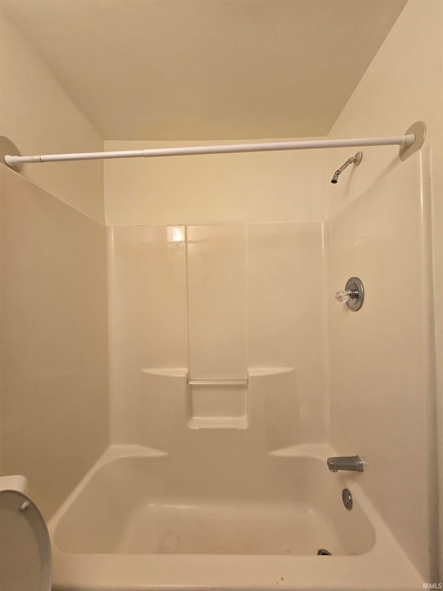 bathroom featuring toilet and shower / bathtub combination