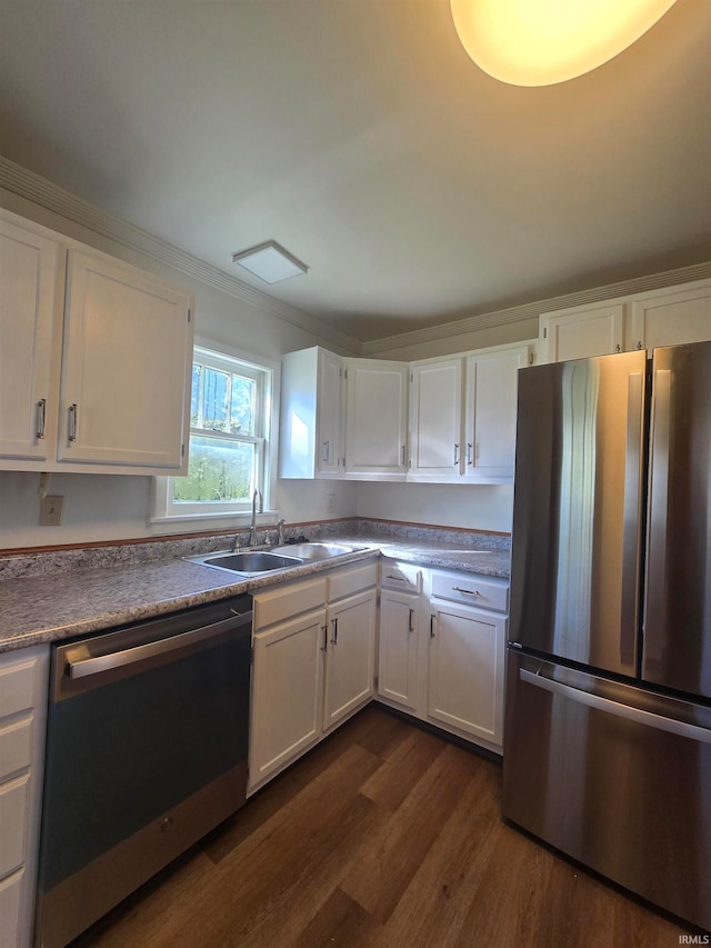 kitchen with stainless steel appliances, sink, and white cabinets