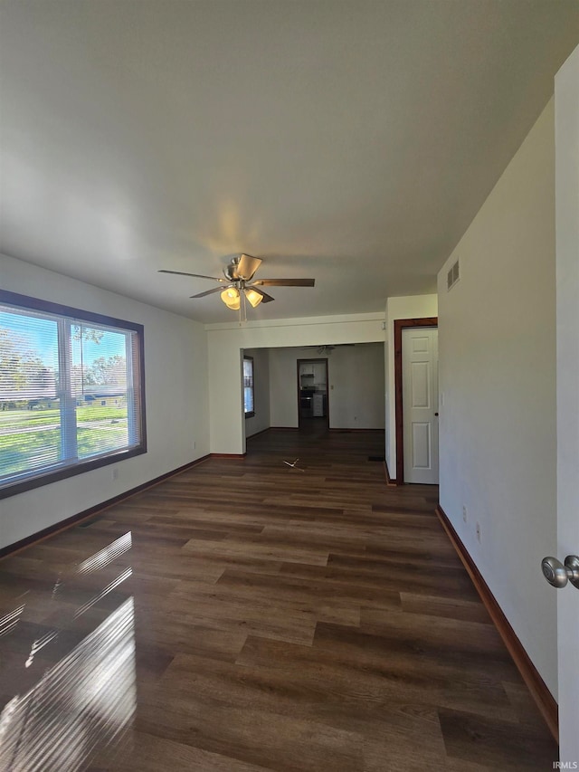 spare room featuring dark hardwood / wood-style floors and ceiling fan