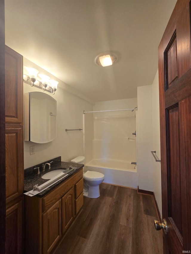 full bathroom featuring vanity, shower / bathing tub combination, hardwood / wood-style flooring, and toilet