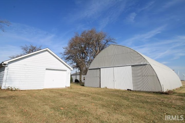 view of outbuilding featuring a lawn