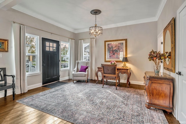 living area with a notable chandelier, ornamental molding, and dark hardwood / wood-style floors