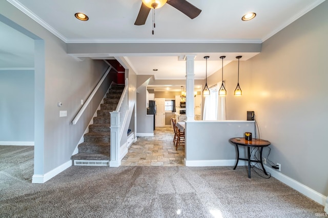 carpeted entryway featuring crown molding and ceiling fan