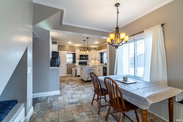 dining room featuring crown molding, sink, a notable chandelier, and a wealth of natural light