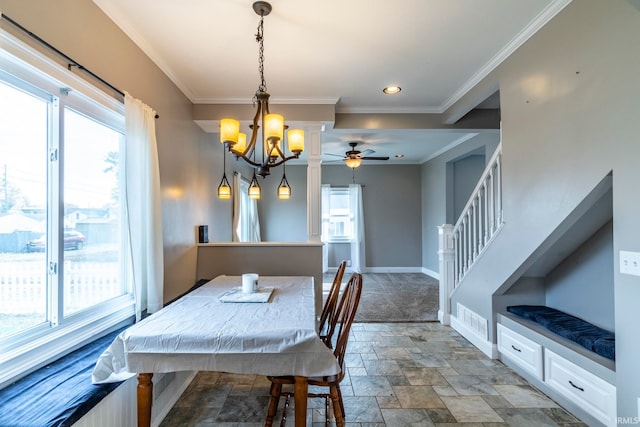 dining space with crown molding and ceiling fan with notable chandelier