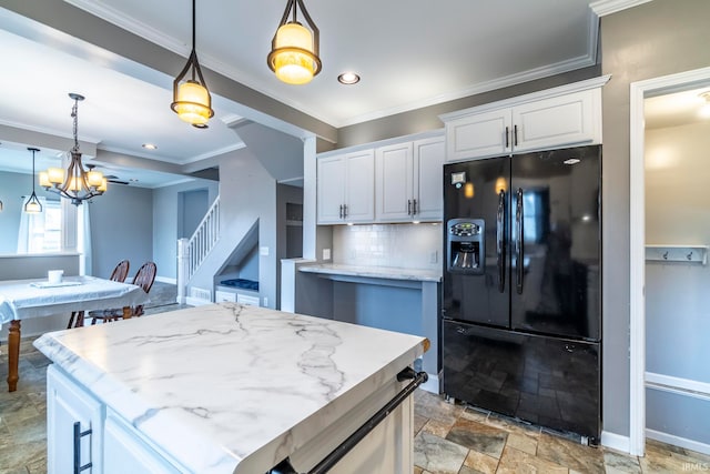 kitchen with white cabinets, hanging light fixtures, a kitchen island, backsplash, and black fridge with ice dispenser