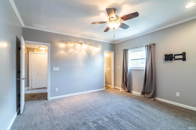 carpeted spare room with ornamental molding and ceiling fan