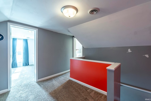 bonus room with lofted ceiling and carpet floors